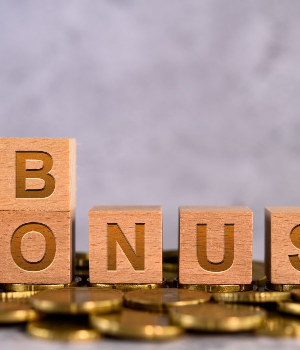 Bonus word alphabet wooden cube letters placed on a gold coin